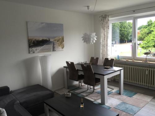 a living room with a table and chairs and a couch at Appartement Moervig in Flensburg