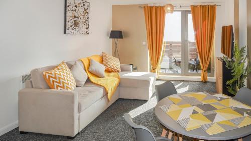 a living room with a couch and a table at Birmingham City Centre Apartment Near New Street Station The Cube Mailbox Brindley Place Ace Apartment in Birmingham