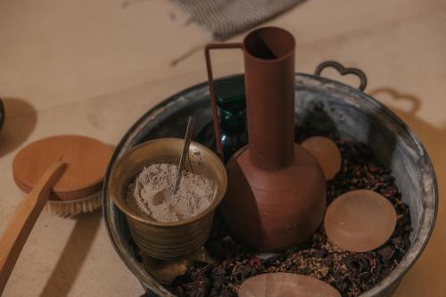 a glass bowl filled with dust and other items on a table at Shizen Wellness Hotel in Drama