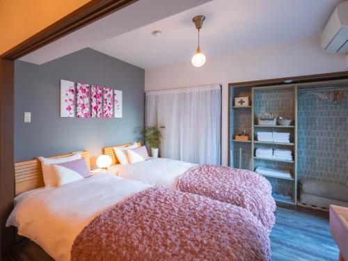 Ένα ή περισσότερα κρεβάτια σε δωμάτιο στο Vacation Rental 205- 駐車場無料