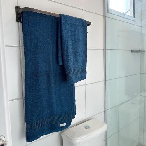 a bathroom with two blue towels hanging above a toilet at Luna 03 Prime Loft in Extrema