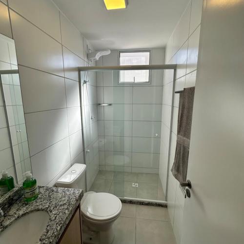 a bathroom with a toilet and a sink and a shower at Luna 03 Prime Loft in Extrema