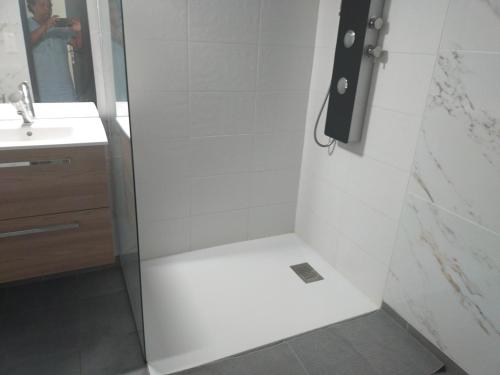una doccia con una porta in vetro in un bagno di Maison neuve Hourtin , 3 chambres, proche commodités, clôturée, climatisation, terrasse a Hourtin