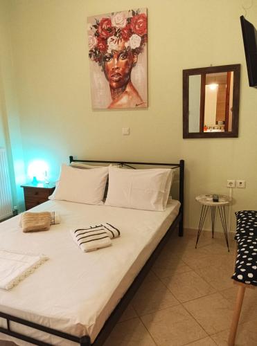 a bedroom with a bed with towels on it at Olga's House in Preveza