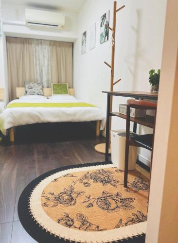 a room with two beds and a rug at Shinjuku city西新宿 in Tokyo