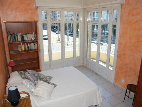 a bedroom with a bed and a book shelf at Palais HenriIV in Nice