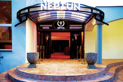 a entrance to a hotel with a sign on it at Neptun Ψ Resort in Jastrzębia Góra