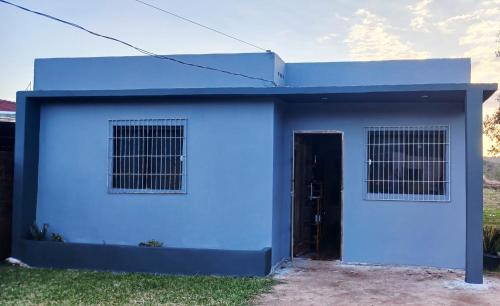 a blue and white garage with a door at HospedaJeremias in Encarnación