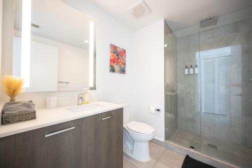 a bathroom with a shower and a toilet and a sink at Luxury Loft - Free Parking - Skyline Views - Brickell Downtown in Miami