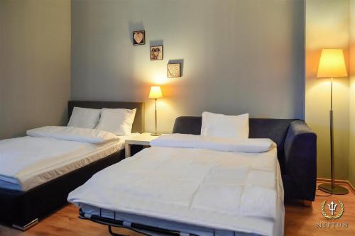 a hotel room with two beds and a couch at Neptun Ψ Resort in Jastrzębia Góra