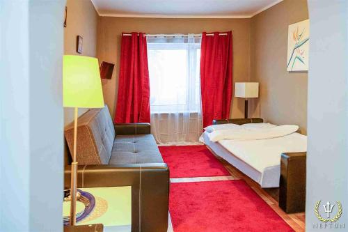 a small bedroom with a bed and a red rug at Neptun Ψ Resort in Jastrzębia Góra