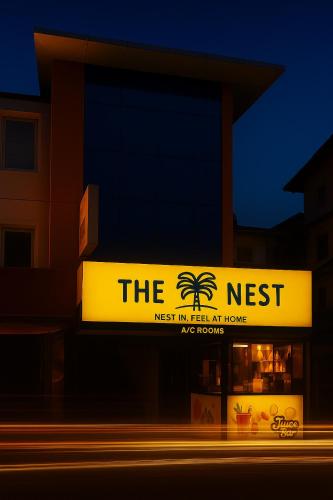 a sign for the nest next to a building at The Nest in Trichūr