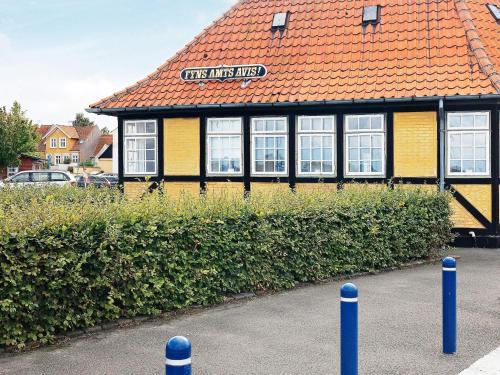 a building with an orange tile roof and windows at 4 person holiday home in Ærøskøbing-By Traum in Ærøskøbing