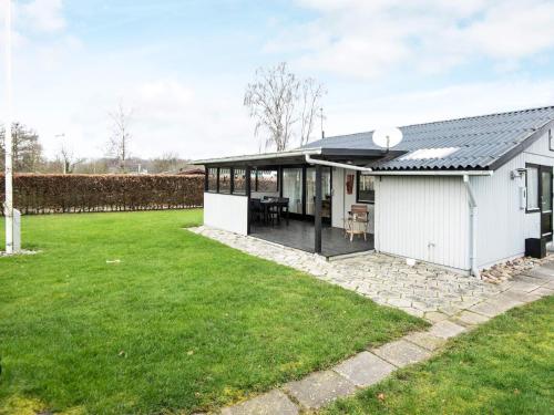a white house with a lawn in front of it at 6 person holiday home in Nordborg in Nordborg