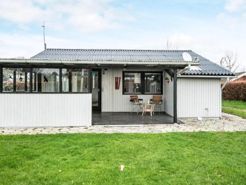 a white house with a black roof at 6 person holiday home in Nordborg in Nordborg