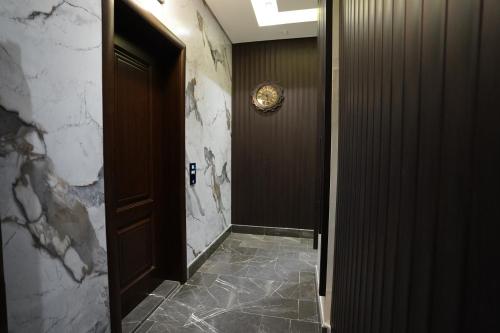 a hallway with a door and a tile floor at 3BR next to stars avenue in Jeddah