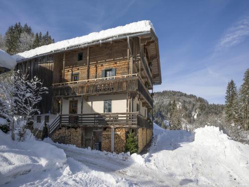 a log cabin in the snow with snow around it at Farmhouse in Hopfgarten near Ski Bus in Hopfgarten im Brixental