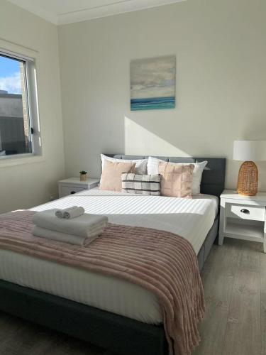 a bedroom with a large bed and a window at Hidden 2 Bedroom Getaway in Kingsgrove in Sydney