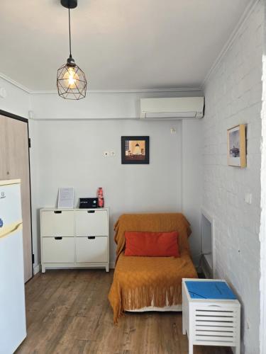 a bedroom with a bed with a orange blanket at Acropolis View Sky Suite with Jacuzzi near Metro in Athens