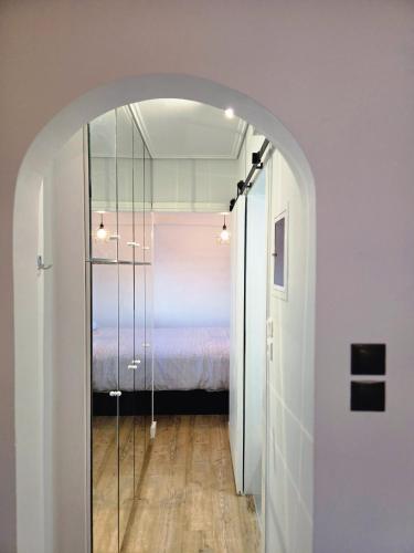 an arched hallway with a bed in a bedroom at Acropolis View Sky Suite with Jacuzzi near Metro in Athens