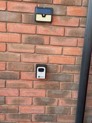 a brick wall with a pay phone on it at Guest Room by Amanda & David in Devizes Wiltshire in Bishops Cannings