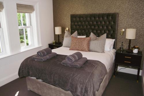a bedroom with a large bed with two pillows on it at Luxury Croft Templepatrick Near Airport Rabbit and Hilton hotel in Templepatrick
