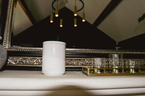 a candle on a table in front of a mirror at Luxury Croft Templepatrick Near Airport Rabbit and Hilton hotel in Templepatrick