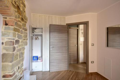 a room with a stone wall and a door at Petra Holiday Home in Pietrapertosa