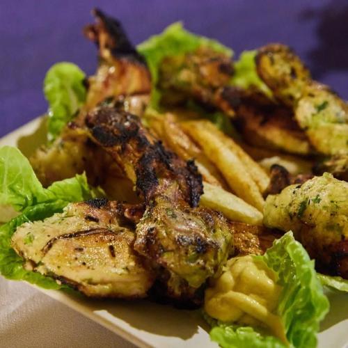a plate of food with chicken and french fries at Cafe Restaurant Moove Oil in Rissani