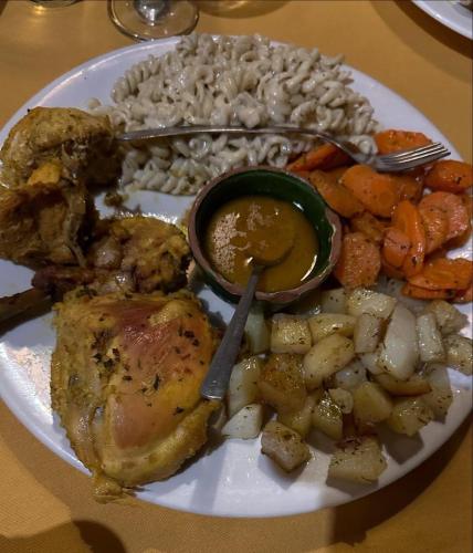a plate of food with chicken and vegetables on a table at Cafe Restaurant Moove Oil in Rissani