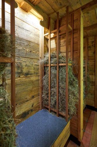 an inside of a chicken coop with hay at Hotel Weiss in Angermünde
