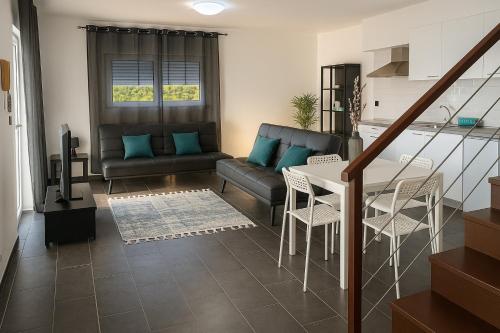 a living room with a couch and a table at Batalha Village View in Batalha