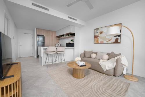 a living room with a couch and a table at Queen's Wharf 1Bed Apt - Lv 60 Skyline Reverie in Brisbane