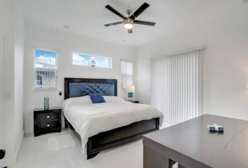 a bedroom with a bed and a ceiling fan at Modern 3BED 2BATH House in Fort Lauderdale in Fort Lauderdale