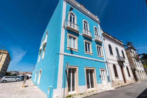 a blue building on the side of a street at T2 Luxo Mobilado in Figueira da Foz