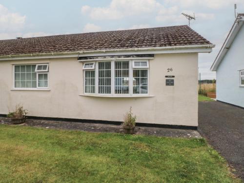 a house with a large window in a yard at Awel-Y-Mor in Swansea