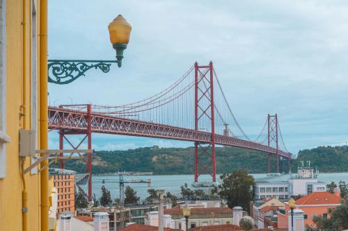 a view of a red bridge from a building at Hotel Infante Santo - Lisboa in Lisbon