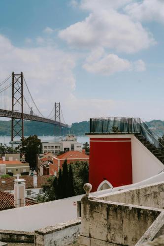 a view of the golden gate bridge from a building at Hotel Infante Santo - Lisboa in Lisbon