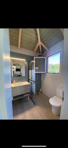 a bathroom with a sink and a toilet and a window at Fiskouri Anthem in Preveza