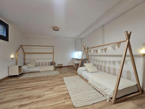 a large room with two beds and a desk at Chez Marie in La Muela