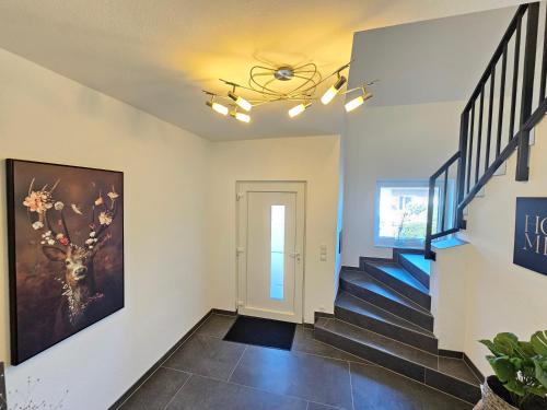 a staircase in a house with a painting on the wall at EcoCube 2 Haren - Sonnenbalkon, Badewanne, Waschmaschine in Bahnhof Haren