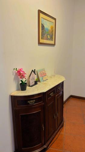 a counter with flowers on it in a room at Quarto com varanda no centro de viseu in Viseu