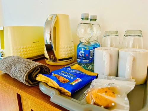 a kitchen counter with food and bottles of milk at Cozy Comfort Home in Stoke on Trent