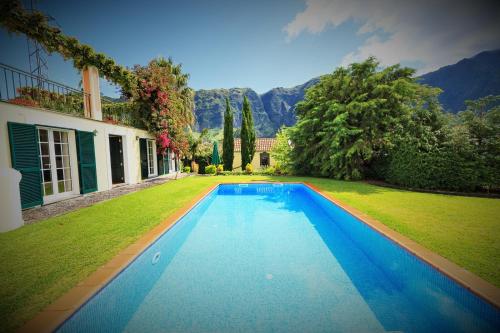 a swimming pool in the yard of a house at Casa da Portada in São Vicente