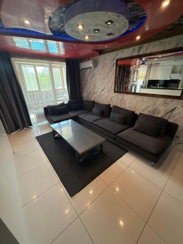 a living room with a couch and a table at LADA Apartment in Nesebar