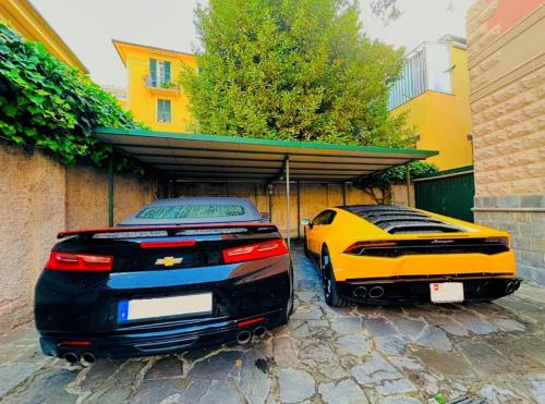 two lamborghinis parked in a garage next to a building at HOTEL Mirarti in Rapallo