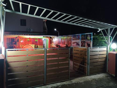 a fence in front of a fire truck at night at Radhe Homestay Malpe Beach side, udupi in Malpe