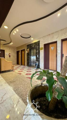 a lobby with a pond in the middle of a building at البندقية للخدمات الفندقية BQ HOTEL SUITES in Buraydah