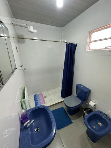 a bathroom with a blue sink and a toilet at Departamento amueblado con Cine, balcón y céntrico in Bella Vista