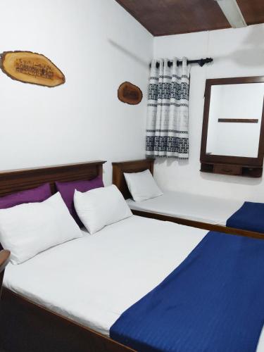 Ένα ή περισσότερα κρεβάτια σε δωμάτιο στο Green Holiday Inn